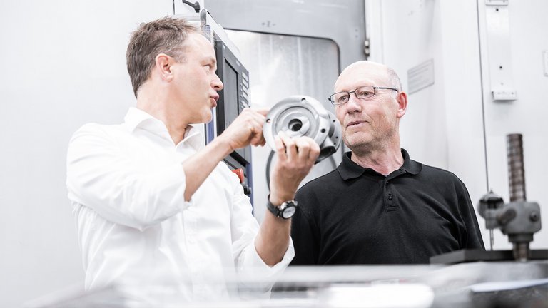 Angestellte der Scherzinger Pumpen GmbH bei der Begutachtung einer Pumpe für eine Anwendung.